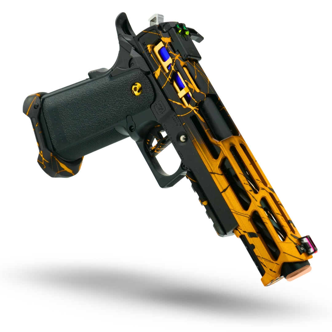 Fully upgraded Tokyo Marui Hi-Capa custom gas blowback pistol with hand anodized splatter finish in metallic blue, emerald green, and gold, pre-built by Minnesota Airsoft with CNC parts, tactical magwell, and tuned internals for speedsoft and IPSC.